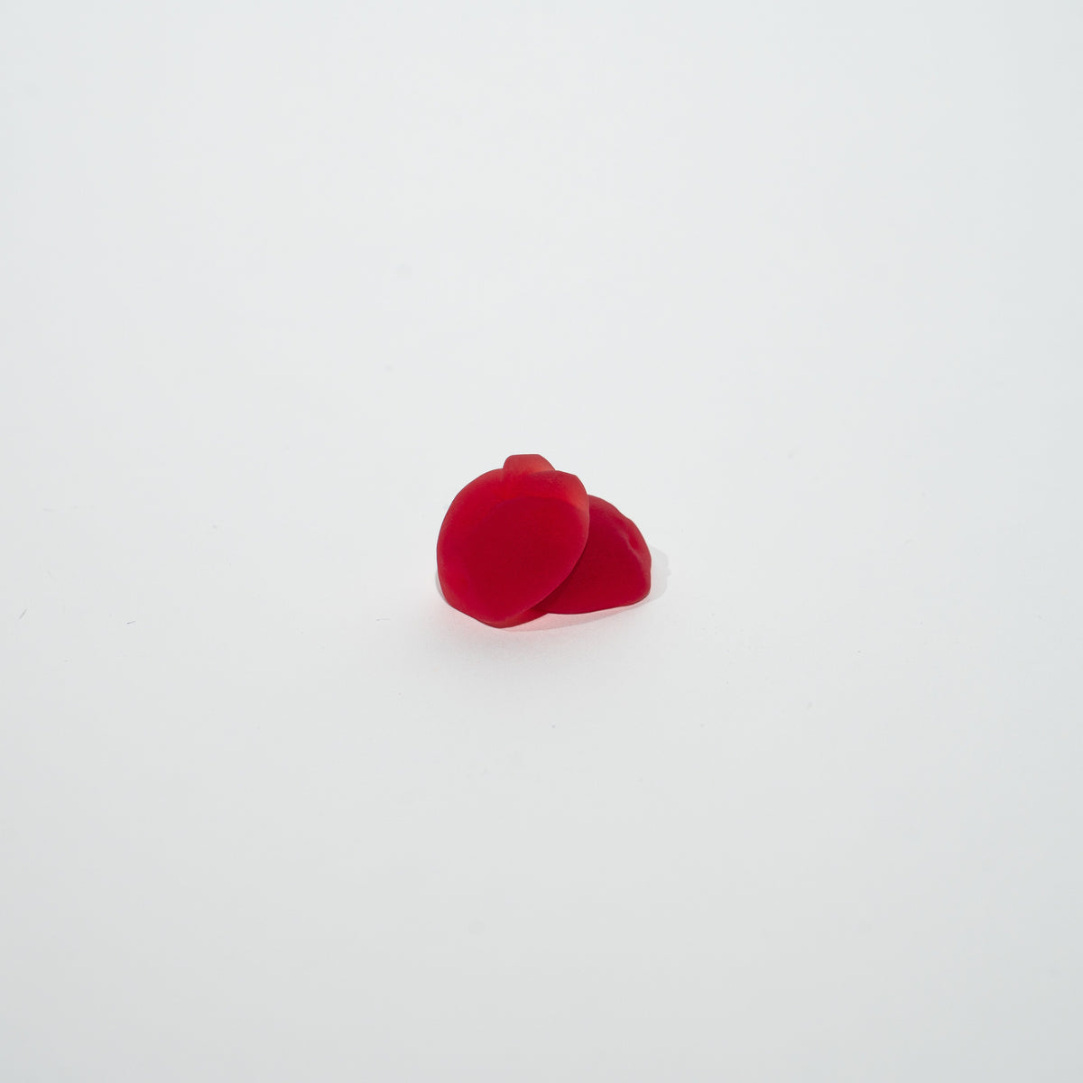 Two red gummies on a white background