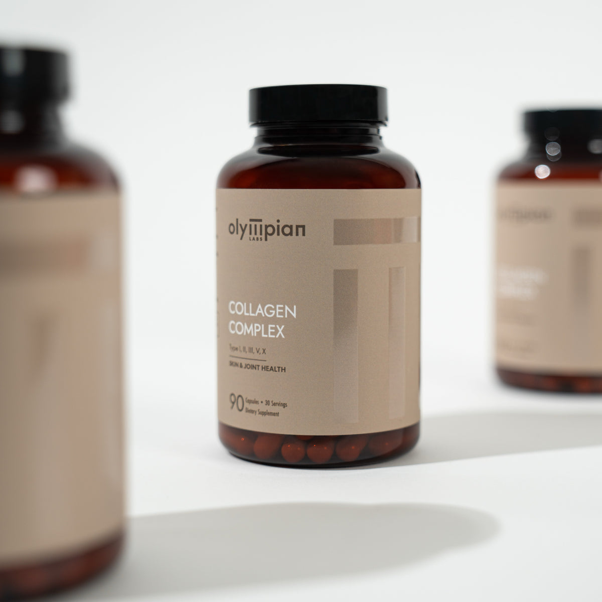 Three bottles of Olympian Labs Collagen Complex on a white surface