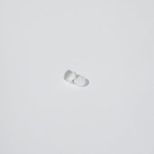 White tablets on a light gray background