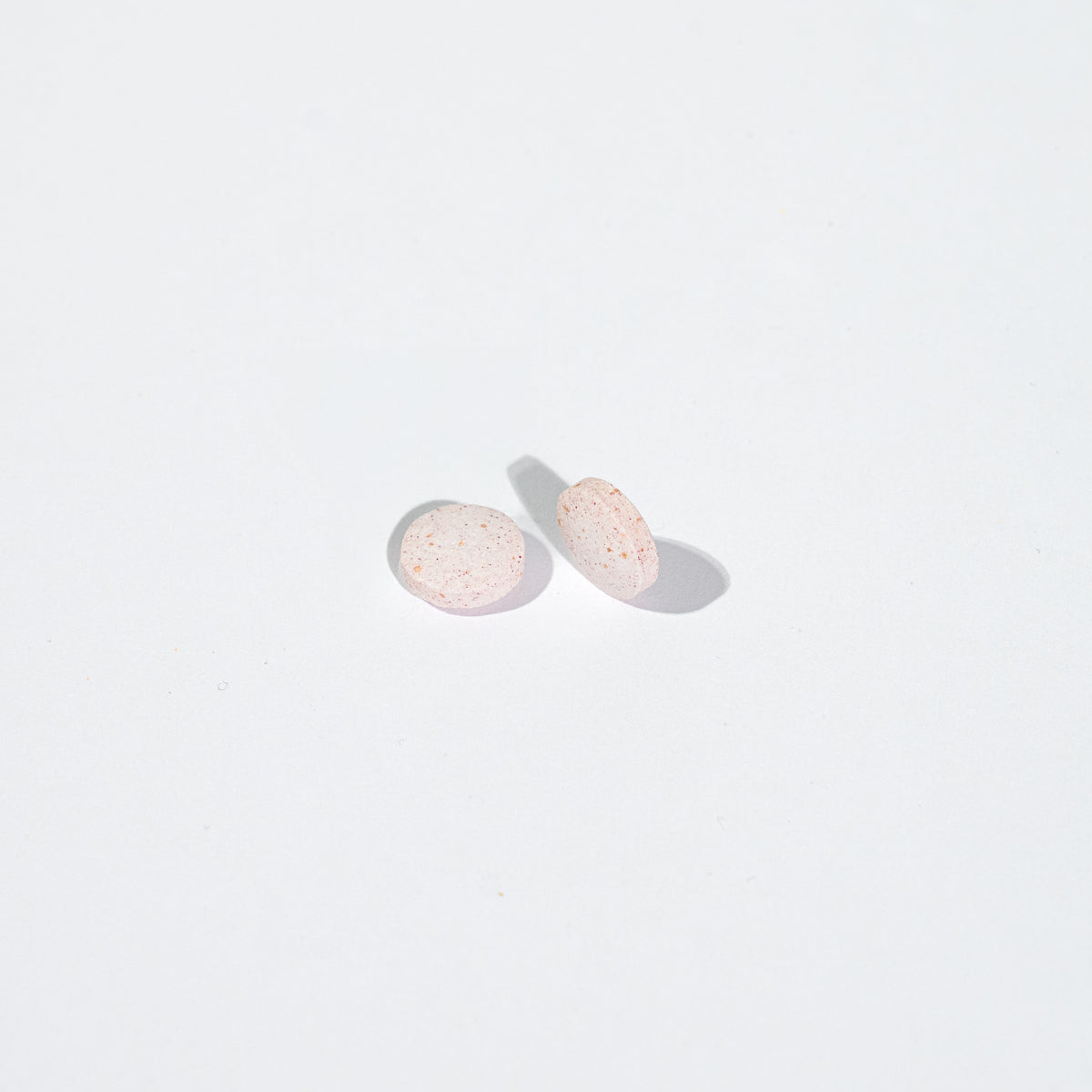 Two round tablets on a white background