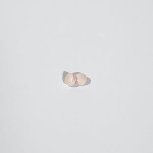 Two small round objects on a light gray background