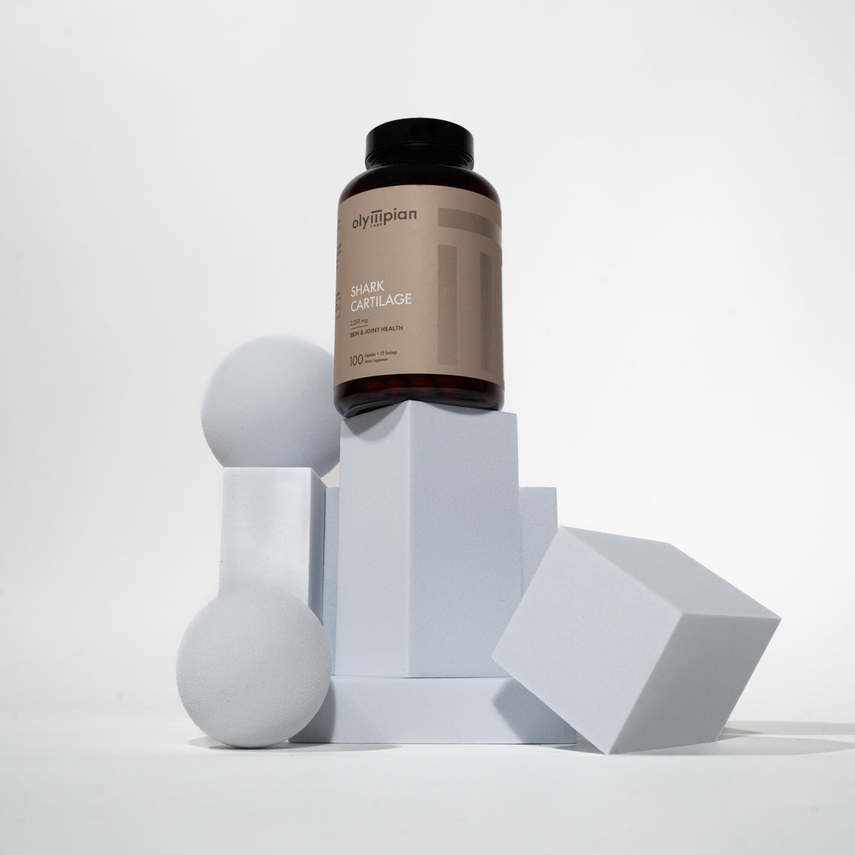 Supplement bottle on geometric shapes with a white background
