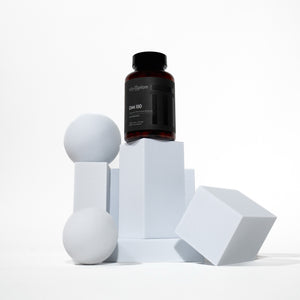 Bottle of DIM 150 on geometric white blocks with a white background
