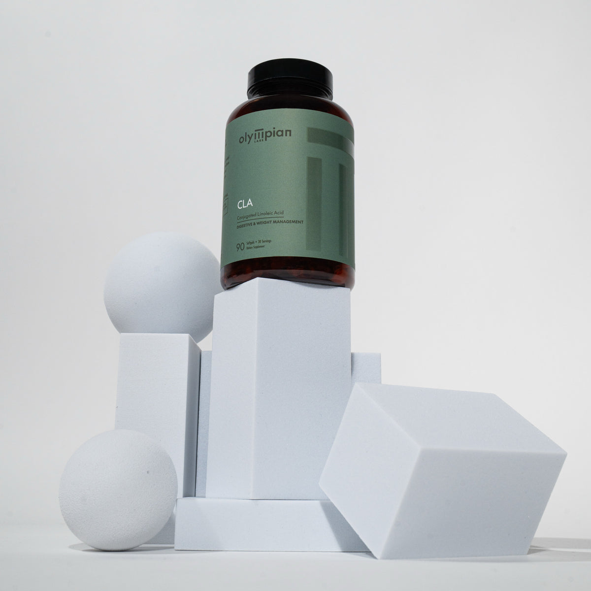 Supplement bottle labeled CLA on geometric white blocks against a light gray background