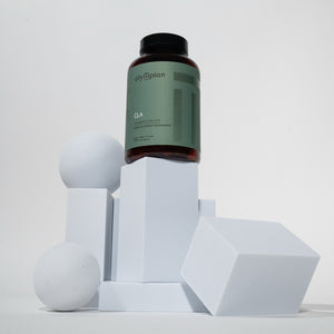 Supplement bottle labeled CLA on geometric white blocks against a light gray background