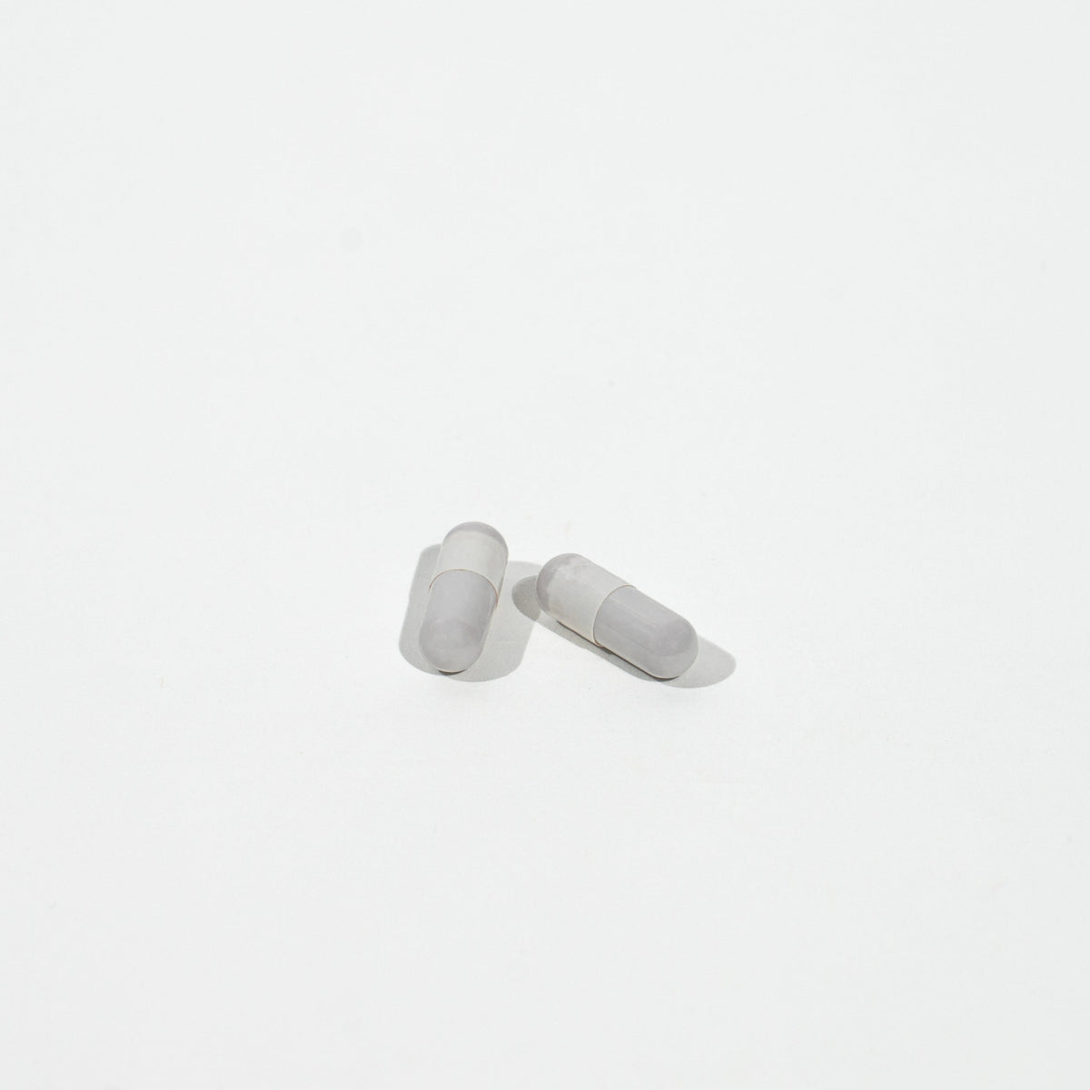 Two gray Pills on a white background