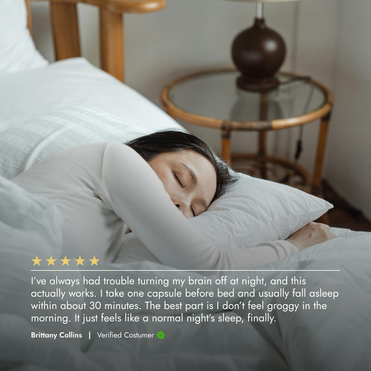 Person sleeping in bed with a pillow, surrounded by soft bedding.