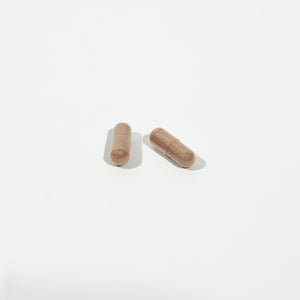 Two wooden capsules on a white background