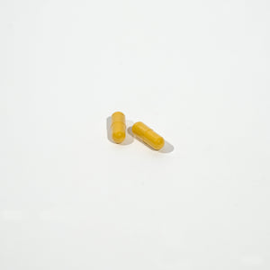Two yellow capsules on a white background