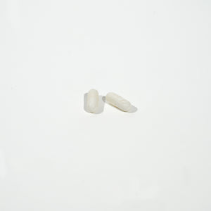 White capsules on a light gray background