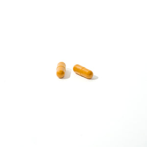 Two yellow capsules on a white background